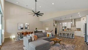 A modern living room with a gray sectional sofa, a wooden coffee table, and a patterned rug. - The Liftview: 3BR home at Purgatory Resort (Durango)