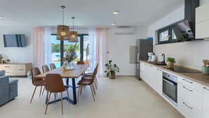 Un appartement moderne comprenant un coin repas, une cuisine et un espace de vie.
