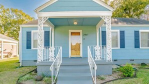 A two-story house with a blue exterior, white trim, and a front porch with white railings. - Close to Midtown & Parks - Little Blue (Mobile)