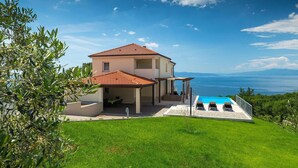 A two-story house with a swimming pool, a covered patio, and a view of the sea. - Awesome home in Kostrena (Kostrena)