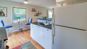 A kitchen with white cabinets, a sink, a refrigerator, and a ceiling fan. - Ann Arbor Home w/ Deck, 2 Mi to Michigan Stadium! (Ann Arbor)