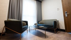 A modern room with a sofa, a chair, and a coffee table. - Rest & More by Dedeman Mersin Erdemli (Erdemli)