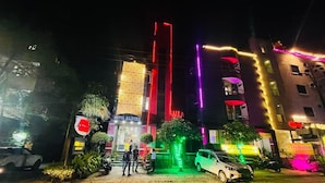 A hotel with a prominent vertical light display and a sign reading "HOTEL ALPINE". - Hotel Alpine By The Golden Taj Group (Agra)