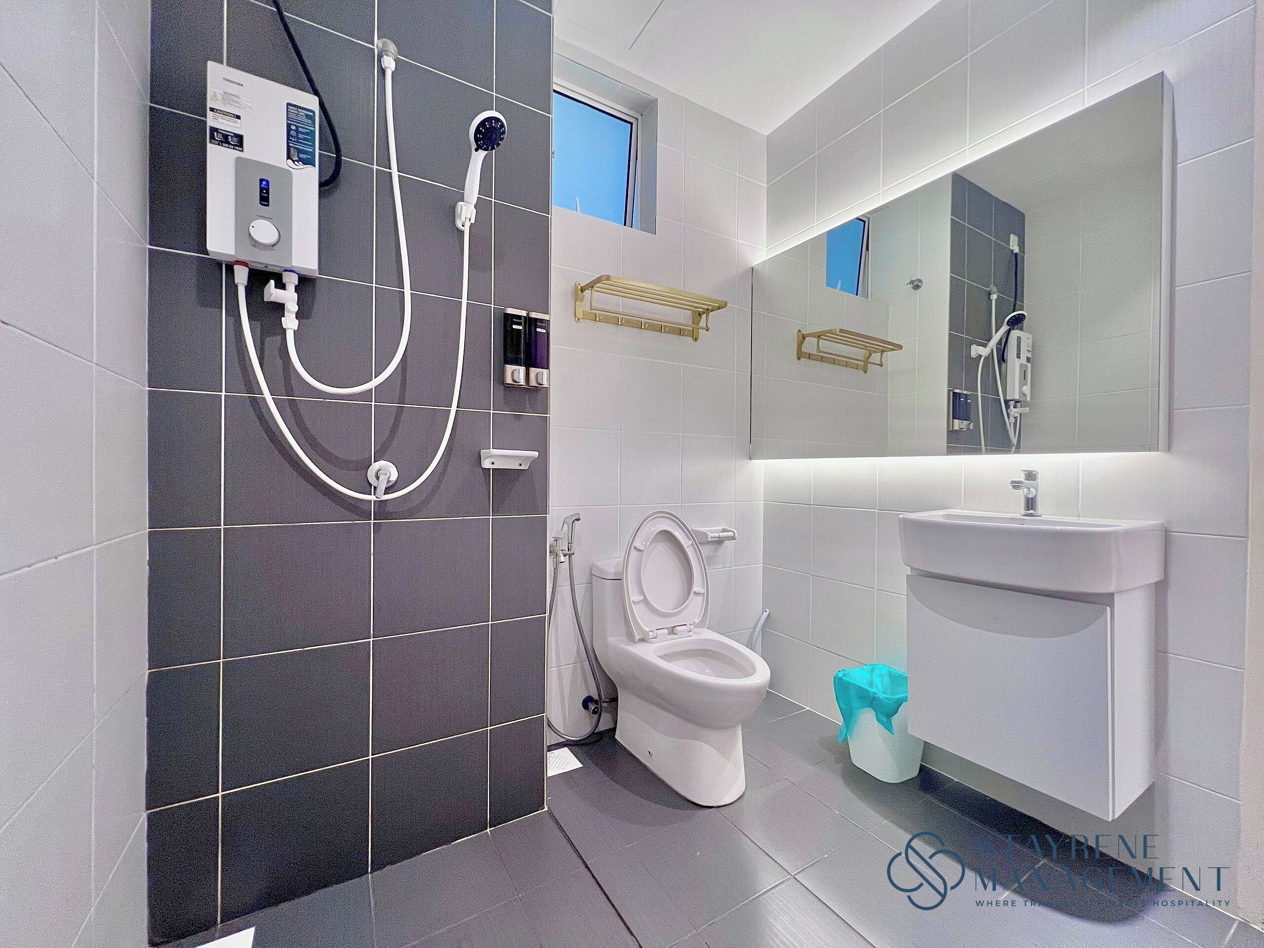 A modern bathroom with a toilet, bidet, and sink.