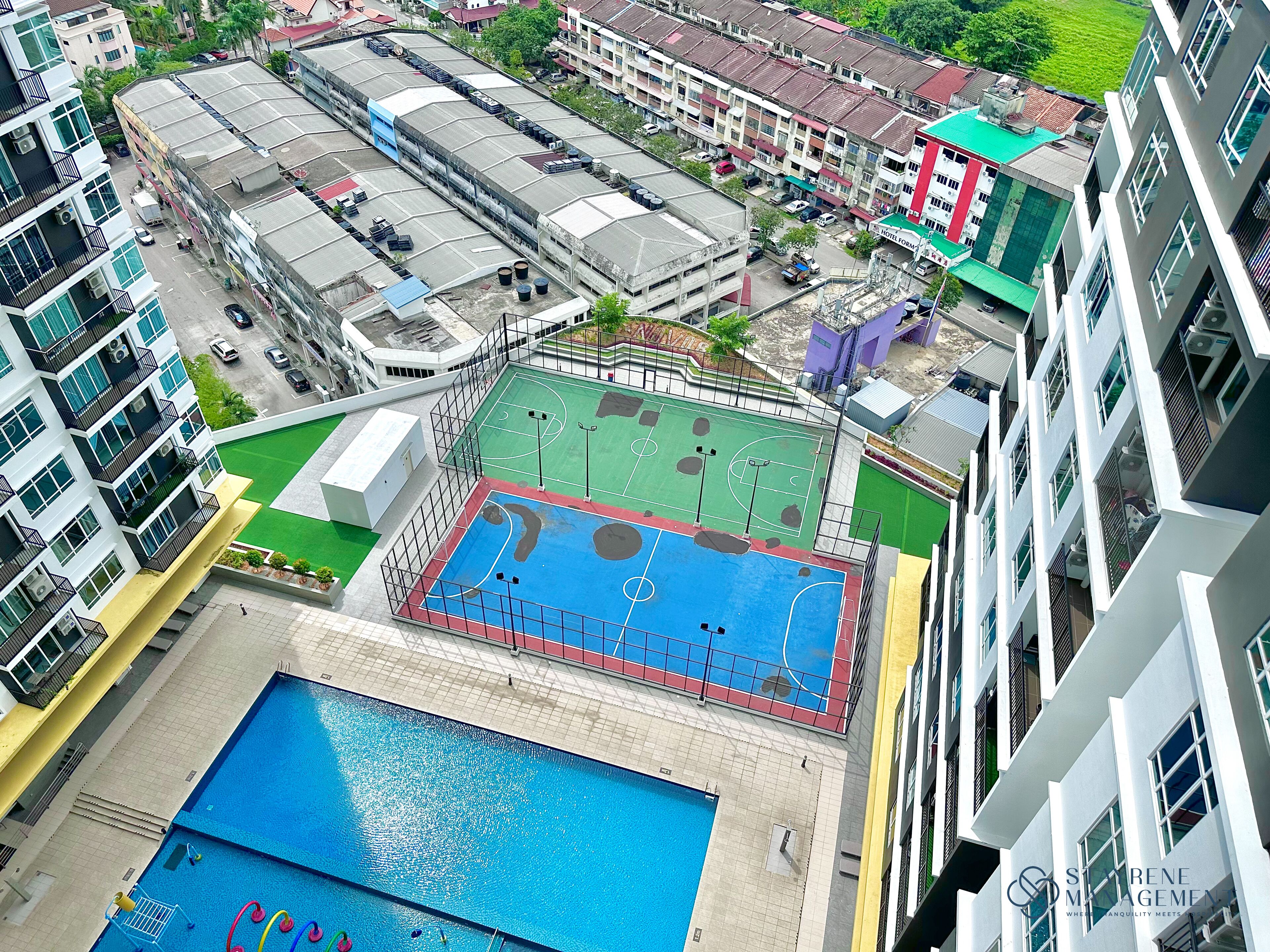 A high-rise building with a rooftop pool and a basketball court.