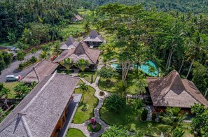 A resort with multiple thatched-roof buildings, a swimming pool, and lush greenery. - Permata Ayung - Exclusive Private Estate Sanctuary with 10 rooms and 2 twin room (Badung)