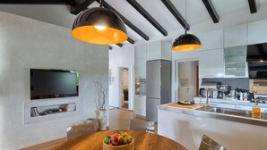 A modern kitchen with a central island, built-in appliances, and pendant lighting. - Amazing home in Rovinj (Rovinj)