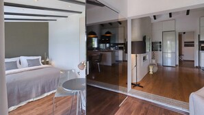 A modern hotel room with a bed, a small table, and a glass partition. - Amazing home in Rovinj (Rovinj)