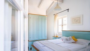 A bedroom with a bed, a wardrobe, a window, and a pendant light. - Awesome home in Pula with sauna (Pula)