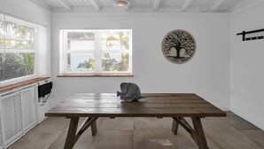 A room with a wooden table, a window with blinds, a radiator, and a wall-mounted artwork. - Biscayne Shore-Stylish 3BR Tropical Family Retreat (Miami)
