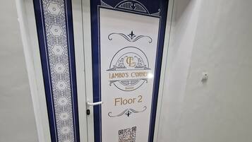 A door with a decorative design and text indicating "Lambo's Corner" and "Floor 2".