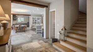 A spacious living area with a dining table, sofa, and a staircase. - Awesome home in Porec (Porec)