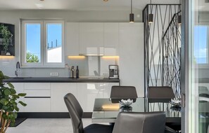 Enjoy cooking in this well-equipped kitchen with a sink, coffee machine, and ample counter space.