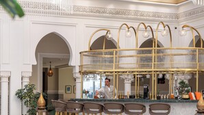 A spacious lobby with a bar area, seating, and a staircase. - Four Seasons Hotel Rabat At Kasr Al Bahr (Rabat)
