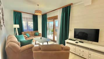 Deluxe Villa | Living area | 32-inch LCD TV with cable channels