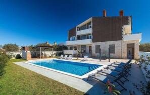 A modern two-story house with a swimming pool, outdoor seating, and a garden. - Beautiful home in Pula (Pula)
