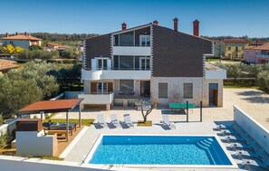 A two-story house with a swimming pool, outdoor seating, and a garden. - Beautiful home in Pula (Pula)