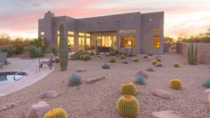 A modern building with a pool, surrounded by cacti and pebbles. - Luxury Retreat with Heated Pool in Scottsdale (Scottsdale)