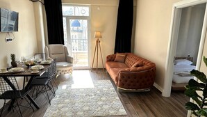 A modern living room with a sofa, dining table, and chairs. - CAPPADOCIA SUIT RESIDENCE (Nevsehir)