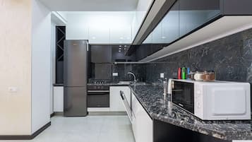 Comfort Apartment | Private kitchen | Fridge, stovetop, electric kettle, griddle