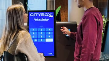 A check-in/check-out kiosk with a digital screen displaying a keypad and a "CITYBOX" logo.