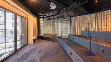 A modern interior with large windows, a seating area, and a counter.