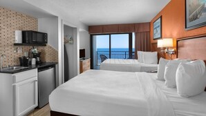 A hotel room with two beds, a kitchenette, and a balcony with a view of the sea. - Beachside Serendipity Oceanfront 2 Bedroom (Myrtle Beach)