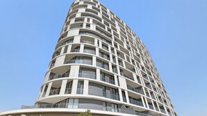 A modern high-rise building with a curved facade, multiple balconies, and large windows. - Ellipse Waterfall 31015 (Midrand)
