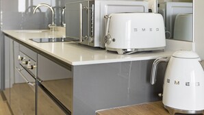 A kitchen with a white toaster, a kettle, and a modern faucet. - Ellipse Waterfall 31015 (Midrand)