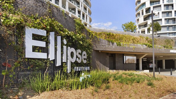 A modern building with a prominent 'Ellipse' sign, surrounded by greenery and a parking area. - Ellipse Waterfall 31002 (Midrand)