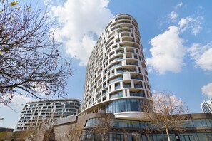 A modern high-rise building with multiple balconies and large windows. - Ellipse Waterfall 3802 (Midrand)