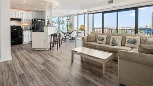 A modern apartment with a kitchen, dining area, and living room.