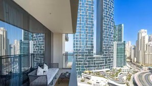 A high-rise building with a modern design, featuring a balcony with outdoor furniture. - Vogue | 52|42 Marina near Ain Dubai | JBR Beach (Dubai)