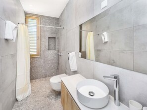 A modern bathroom with a round sink, a toilet, and a shower area. - Azure Seaview - Garnet Villa (Paralimni)