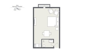 A floor plan of a hotel room with a bed, a desk, a chair, a small table, a wardrobe, and a bathroom with a toilet and sink. - 5003 Alice im Alpenhaus Montafon (Gargellen)