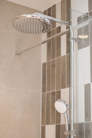 Shower, rainfall showerhead, hair dryer, towels