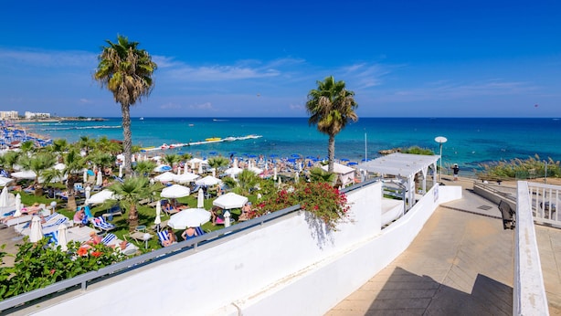 A beachside hotel with a terrace overlooking the sea, sun loungers, and umbrellas. - Olivine Sea Pearl Villa #18 (Paralimni)