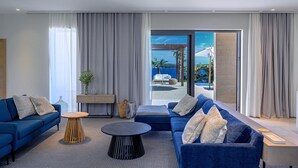 A modern living room with a sofa, coffee table, and a view of the sea. - New Villa/Amazing sea views/close to City and Beach/Heated pool/Sauna/Gym (Hvar)
