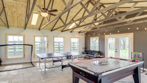 An indoor recreational area with two foosball tables, a pool table, and a ping pong table. - Dry Ridge Rental Home w/ Hot Tub & Game Room! (Crittenden)