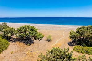 A coastal landscape with a clear view of the sea and a sandy beach. - Villa Pelagos Blue - Four Bedroom Villa, Sleeps 8 (Rhodes)