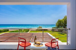 Enjoy ocean views from this balcony with a table set for a relaxing moment.