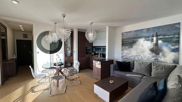 Superior Apartment, Sea View | Living area | 32-inch LCD TV with cable channels