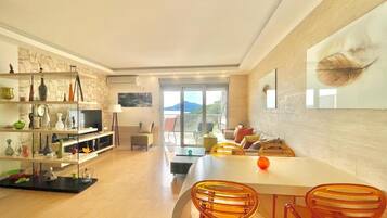 Comfort Apartment | Living area | 32-inch LCD TV with cable channels