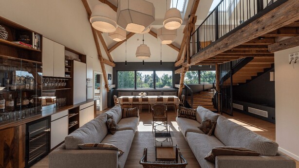 A spacious living area with a large sofa set, a dining table, and a kitchen with wooden beams. - Located in Michelbach, 26 km from Mulhouse train station. (Aspach-Michelbach)