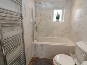A bathroom with a glass-enclosed shower, a bathtub, and a toilet. - Netherdale House (Buxton)