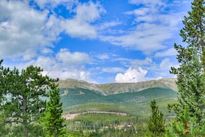 A mountainous landscape with pine trees and a clear sky. - 1107 American Way (Breckenridge)