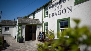 A building with a sign reading "GEORGE AND DRAGON" and a chalkboard sign outside. - George and Dragon Clifton (Penrith)