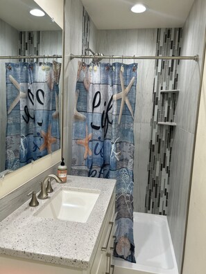 Shower, hair dryer, towels, toilet paper