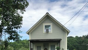 A single-story house with a front porch, a mailbox, and a number 167 sign. - Sweet Escape Cottage on River  (Barton)