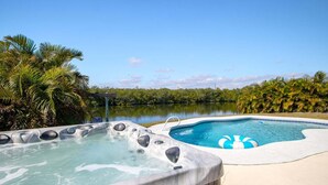 A hot tub and a pool with a clear view of the surrounding landscape. - 106 La Riviere Rd (Cocoa Beach)